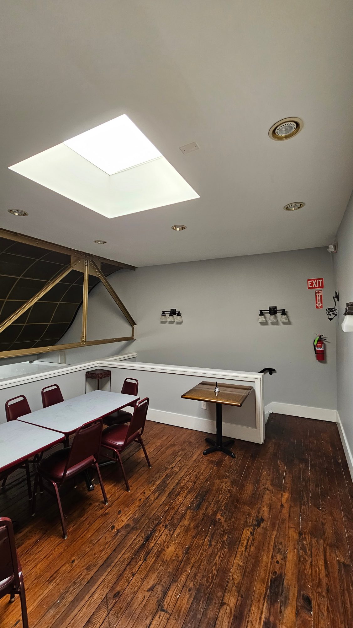 Upstairs private dining room at Punjabi Tadka with a skylight and hardwood floors