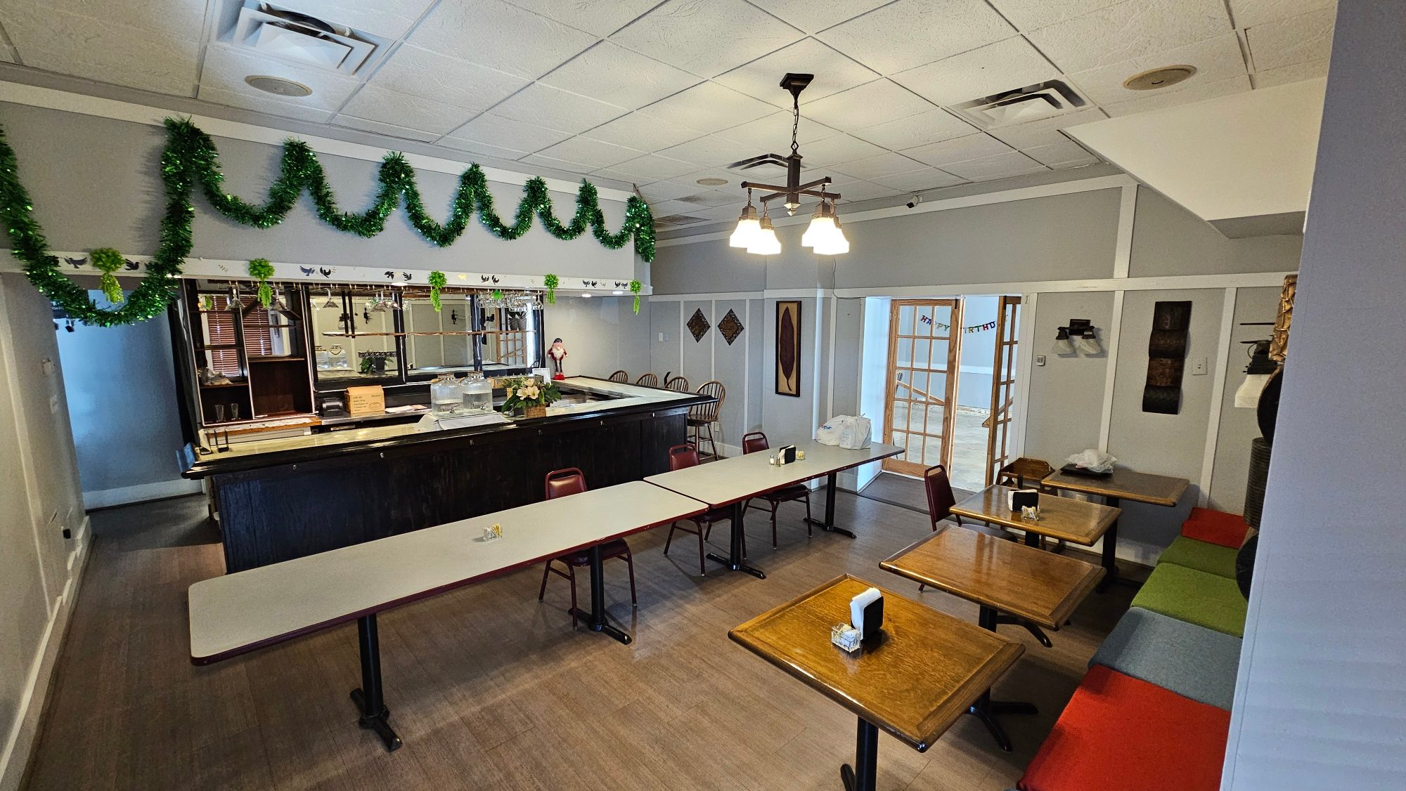 Main dining room and bar at Punjabi Tadka set with long tables